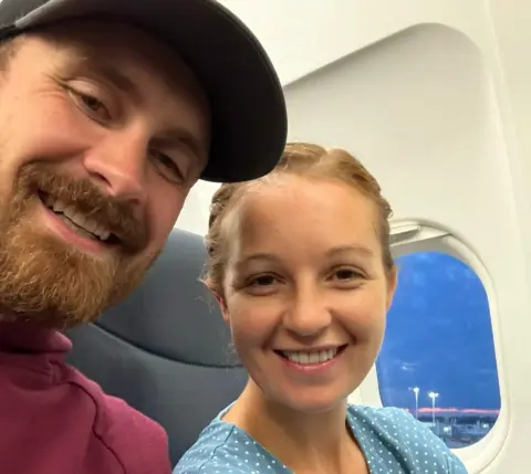 Charlotte and Dana taking a selfie on a plane trip.